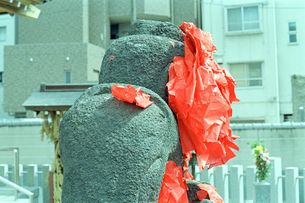 Mysterious statues covered with red paper