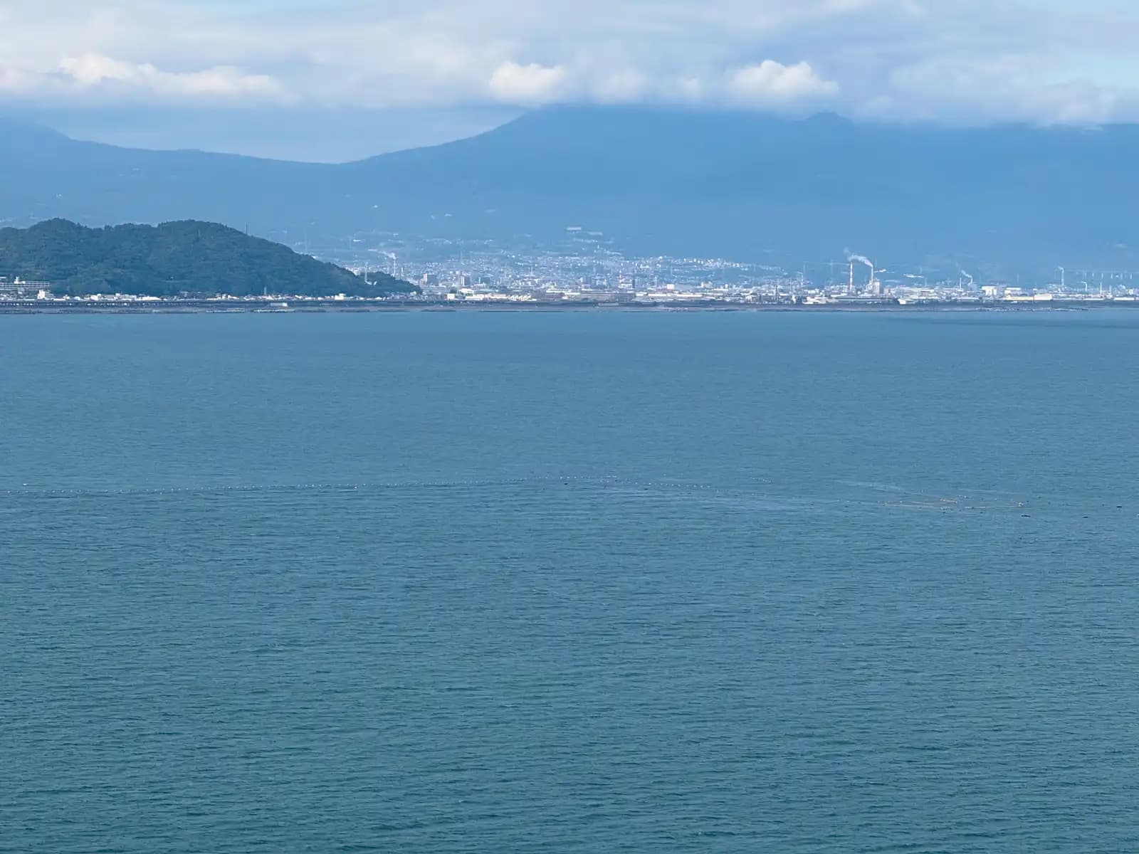 Across the bay, the chimneys of the paper mills in Fuji. The mountain behind them was completely hidden.
