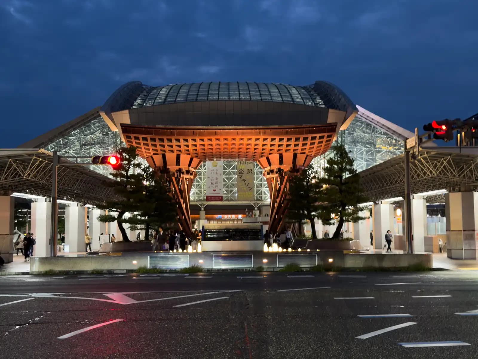 The Tsuzumi Gate and the Motenashi Dome after dark, seen from across the road in front of the station's east exit.