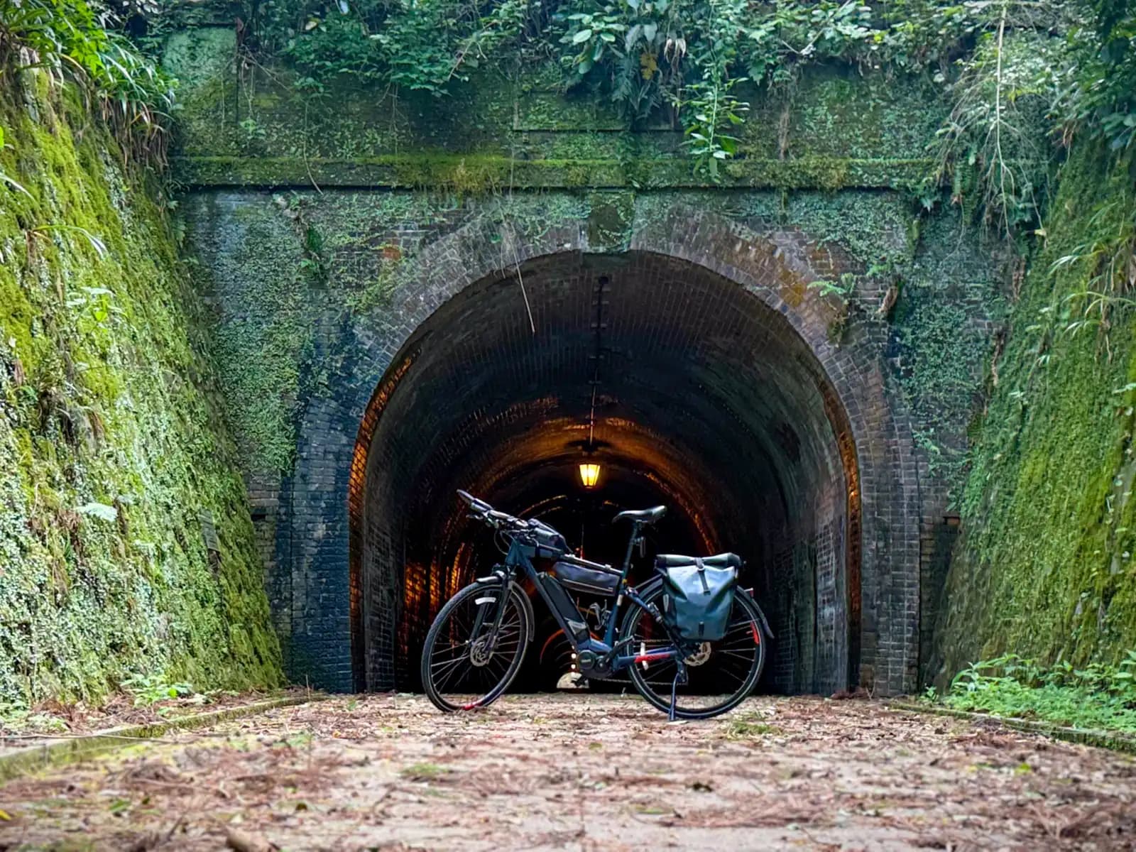 The Beast parked at the tunnel mouth, with a lamp glowing in the dark behind it.