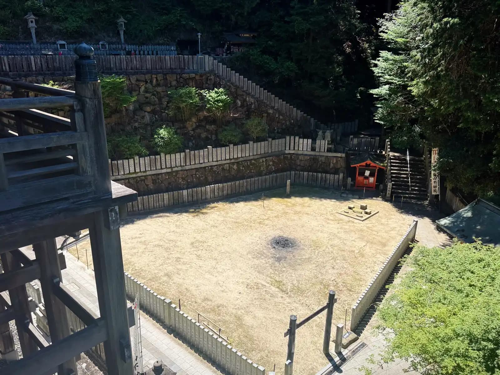 Looking down from the stage onto the fire-ritual court, where the temple's outdoor goma is performed.